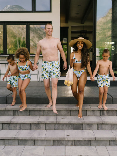 Front View of Family on Steps wearing Navalora Amalfi Coast Lemon Matching Swimsuits 